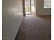 A well lit living room with neutral carpeting and a view of the backyard at 780 Vortex Ave, Henderson, NV 89002