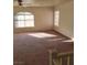 Bright living room featuring neutral walls, ceiling fan, and abundant natural light from multiple windows at 780 Vortex Ave, Henderson, NV 89002
