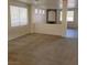 A well lit living room with neutral carpeting, white walls, and an archway to another room at 780 Vortex Ave, Henderson, NV 89002