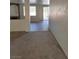 A well lit living room with neutral carpeting and an archway to another room at 780 Vortex Ave, Henderson, NV 89002