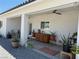 The back patio is covered and features multiple potted plants and ceiling fan at 790 Fort Churchill Rd, Pahrump, NV 89060