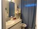 Clean bathroom featuring a vanity with storage and a shower with a stylish curtain at 790 Fort Churchill Rd, Pahrump, NV 89060