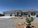 Charming single-story home with a gravel yard, tiled roof, and a two-car garage at 790 Fort Churchill Rd, Pahrump, NV 89060