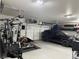 Spacious garage equipped with a home gym area, vehicle, and ample storage solutions at 790 Fort Churchill Rd, Pahrump, NV 89060