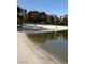 Peaceful beach scene overlooking the lake featuring sand, lounge chairs, and picturesque residential buildings at 8 Reflection Cove Dr, Henderson, NV 89011