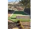 Outdoor bocce ball court surrounded by lush landscaping with residential buildings in the distance at 8 Reflection Cove Dr, Henderson, NV 89011