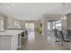 Open-concept living space with a kitchen island, dining area, and sliding glass doors at 8 Reflection Cove Dr, Henderson, NV 89011