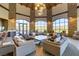Inviting community lobby with a soaring ceiling, stone pillars, elegant seating, and scenic golf course views at 8 Reflection Cove Dr, Henderson, NV 89011