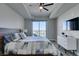 Bright bedroom features a ceiling fan, balcony access, and minimalist decor at 8255 Las Vegas S Blvd # 1414, Las Vegas, NV 89123