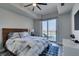 Comfortable bedroom with a ceiling fan and city views from the balcony at 8255 Las Vegas S Blvd # 1414, Las Vegas, NV 89123