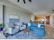 Comfortable living room with a blue sectional sofa, two chairs, and an adjacent dining area at 8255 Las Vegas S Blvd # 1414, Las Vegas, NV 89123