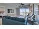 Stylish living room with a comfortable blue sofa, two chairs, and natural light coming through windows at 8255 Las Vegas S Blvd # 1414, Las Vegas, NV 89123