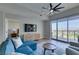 Living room featuring a ceiling fan, natural light, a TV, and access to a bedroom at 8255 Las Vegas S Blvd # 1414, Las Vegas, NV 89123