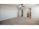 Expansive bedroom showcasing a ceiling fan, a closet, and access to a bathroom, offering comfort at 8278 Palladium St, Las Vegas, NV 89113