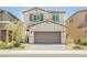 Two-story home featuring a two-car garage, desert landscaping, and a light beige exterior at 8278 Palladium St, Las Vegas, NV 89113