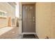 View of the home's front door with welcome mat, and low-maintenance landscaping at 8278 Palladium St, Las Vegas, NV 89113