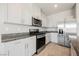 Bright kitchen featuring stainless steel appliances, light cabinetry and granite countertops at 8278 Palladium St, Las Vegas, NV 89113