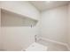 Laundry room area with tiled floors, shelving, and connections for a washer and dryer at 8278 Palladium St, Las Vegas, NV 89113