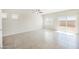 Bright, open living space with neutral walls, tile floors, ceiling fan and slider to backyard at 8278 Palladium St, Las Vegas, NV 89113