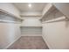 Well-organized walk-in closet with shelving and carpeted floor, offering ample storage space at 8278 Palladium St, Las Vegas, NV 89113