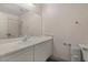 Bathroom with a sink, toilet, vanity mirror, and shower and tub behind the vanity at 8843 Tomnitz Ave # 102, Las Vegas, NV 89178