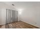 This bedroom has light gray walls, wood-look flooring, and a window covered by a gray and white curtain at 8843 Tomnitz Ave # 102, Las Vegas, NV 89178