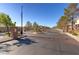 Gated community entrance with brick pillars and decorative landscaping along the sides of the driveway at 8843 Tomnitz Ave # 102, Las Vegas, NV 89178