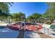 Community fitness area featuring exercise equipment, picnic tables, and sunshades at 8843 Tomnitz Ave # 102, Las Vegas, NV 89178