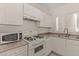 Compact kitchen features white cabinetry and essential appliances at 8843 Tomnitz Ave # 102, Las Vegas, NV 89178