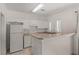 Functional kitchen features white cabinetry and essential appliances at 8843 Tomnitz Ave # 102, Las Vegas, NV 89178