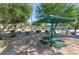 Community picnic area features several tables with sunshades, mature landscaping, and walkways at 8843 Tomnitz Ave # 102, Las Vegas, NV 89178