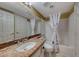 Bathroom with granite countertop vanity, toilet, and shower with white shower curtain at 8914 Termoli St, Las Vegas, NV 89123