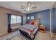 Comfortable bedroom featuring a ceiling fan, carpet, and a natural wood bed frame at 8914 Termoli St, Las Vegas, NV 89123