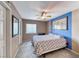 Bright bedroom features carpet, ceiling fan, and a window for natural light at 8914 Termoli St, Las Vegas, NV 89123