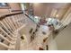 Aerial view of the tiled foyer and staircase with a glimpse into the living room in this two-story residence at 8914 Termoli St, Las Vegas, NV 89123