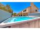 Inviting hot tub area with a view of the backyard and the home's exterior at 8914 Termoli St, Las Vegas, NV 89123
