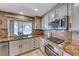 Kitchen featuring granite countertops, stainless steel microwave and oven, and modern cabinets at 8914 Termoli St, Las Vegas, NV 89123