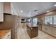 Bright open kitchen with stainless appliances, center island, and a view to a dining and living room at 8914 Termoli St, Las Vegas, NV 89123