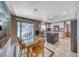 Kitchen with granite counters, stainless steel appliances, open to dining area, and sliding doors to backyard at 8914 Termoli St, Las Vegas, NV 89123