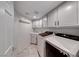 Well-organized laundry room with modern washer and dryer and plenty of cabinet space at 8914 Termoli St, Las Vegas, NV 89123
