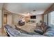 Open living room features a large sectional, fireplace, neutral decor, and plenty of natural light at 8914 Termoli St, Las Vegas, NV 89123