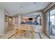 Open-concept living area adjacent to dining area and featuring neutral paint and tile flooring at 8914 Termoli St, Las Vegas, NV 89123