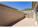 A brick-paved backyard patio enclosed by a block wall offering privacy and shade at 901 Allister Fields Ln, Las Vegas, NV 89138