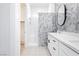 Stylish bathroom with a double vanity, geometric tile accent wall and a glass shower enclosure at 901 Allister Fields Ln, Las Vegas, NV 89138
