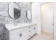 Beautiful bathroom showcasing a double vanity, decorative tile accent wall, and contemporary mirrors at 901 Allister Fields Ln, Las Vegas, NV 89138