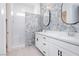Elegant bathroom featuring a double vanity, decorative tile accent wall and glass-enclosed shower at 901 Allister Fields Ln, Las Vegas, NV 89138