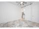 Bright bedroom with ceiling fan, barn door access to bathroom, and contemporary patterned carpet at 901 Allister Fields Ln, Las Vegas, NV 89138