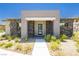 Inviting front facade featuring stone accents, neutral stucco, and desert landscaping at 901 Allister Fields Ln, Las Vegas, NV 89138
