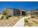 Contemporary home design with stone accents and low-maintenance desert landscaping at 901 Allister Fields Ln, Las Vegas, NV 89138