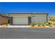 Spacious two-car garage with stone accents, providing ample parking and storage at 901 Allister Fields Ln, Las Vegas, NV 89138